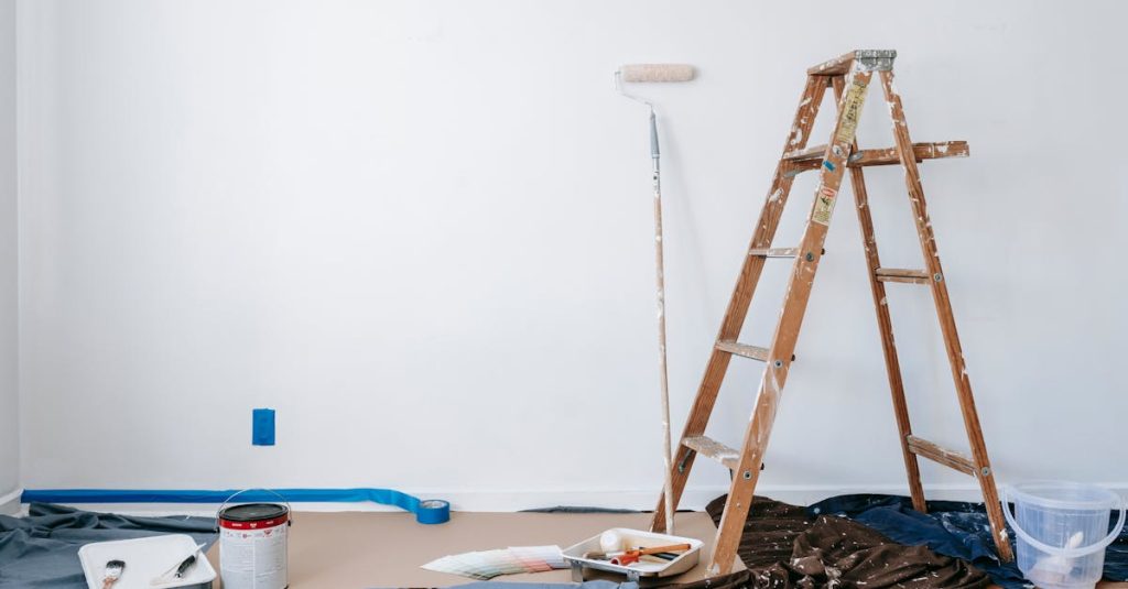 A room prepared for renovation with a ladder, paint supplies, and drop cloth.